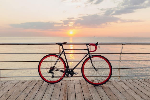 Hipster bicycle in morning sunrise by the sea