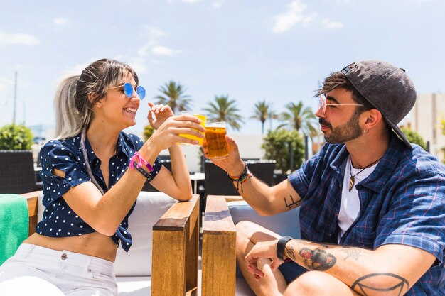 Hipster friends clinking glasses