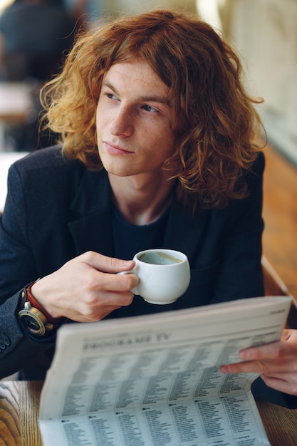 Free Photo hipster man drinking coffee while thinking of future