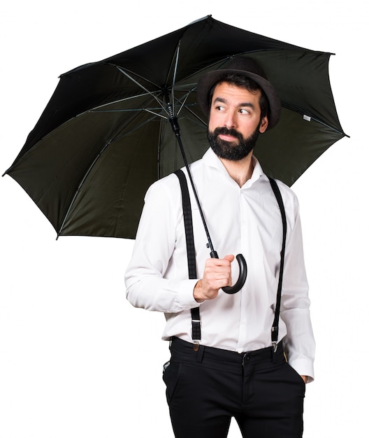 Free photo hipster man with beard holding an umbrella