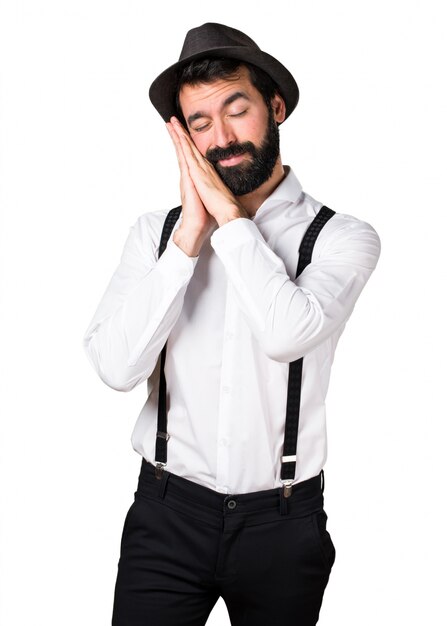 Hipster man with beard making sleep gesture