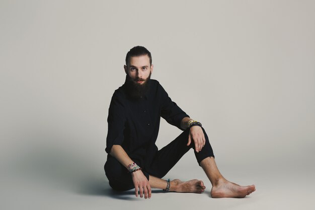 Hipster style bearded man black shirt in studio over white background