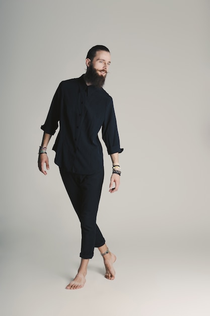 Hipster style bearded man black shirt in studio over white background