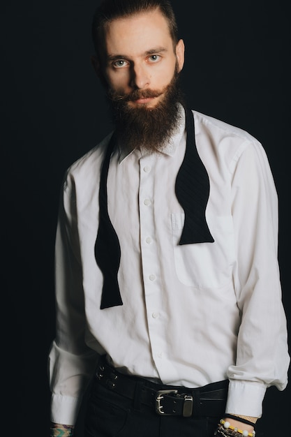 Free Photo hipster style bearded man white shirt in studio over black background