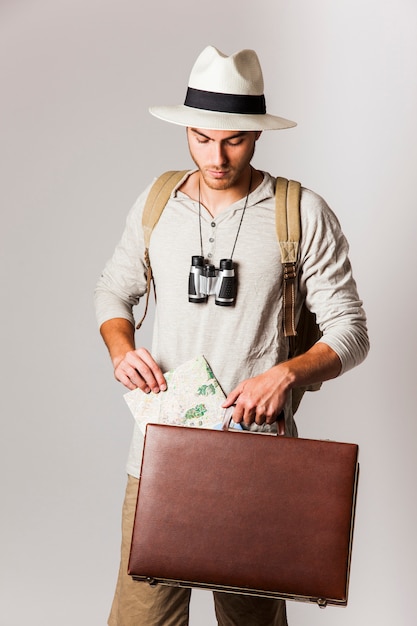 Free Photo hipster style tourist holding suitcase