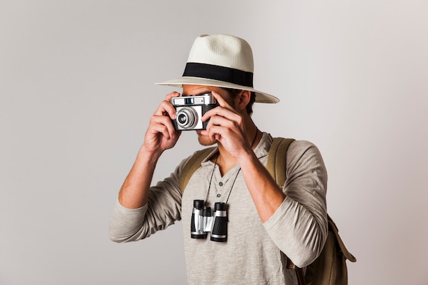 Hipster style tourist taking photo with camera