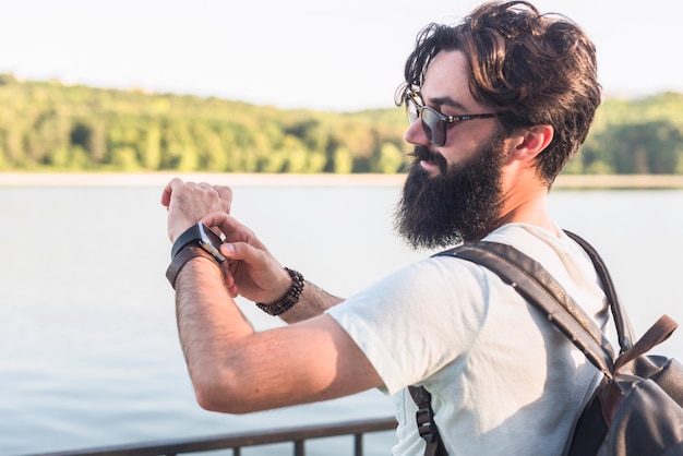 Free photo hipster on vacation next to lake