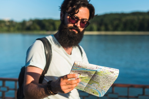 Free photo hipster on vacation next to lake