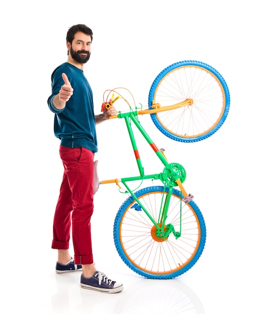 Free photo hipster with thumb up holding a bike