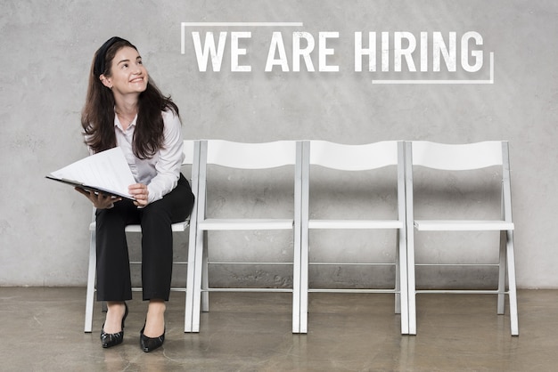 Free Photo hiring concept with person standing on chairs