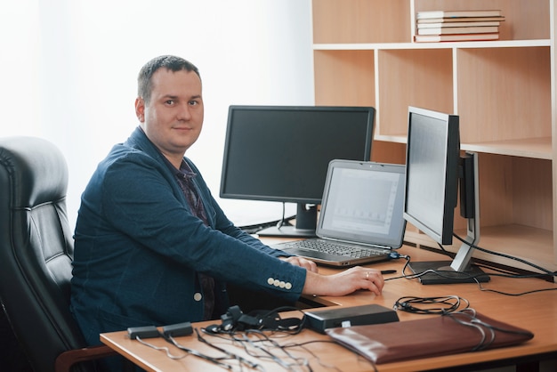 In his own cabinet. Polygraph examiner works in the office with his lie detector's equipment