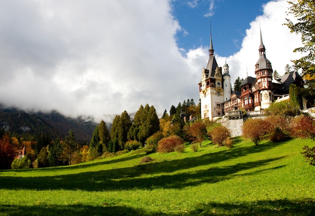 Historical Sinaia Monastery surrounded by green trees in Sinaia, Romania