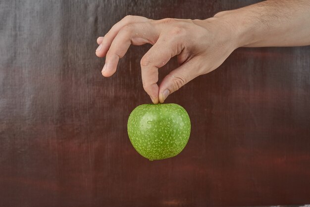 Holding apple in the hand