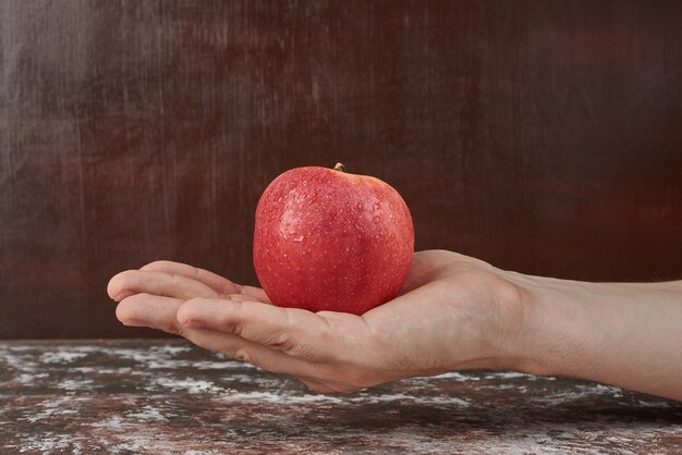 Holding apple in the hand