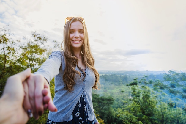 Free photo holding girlfriends hand in countryside