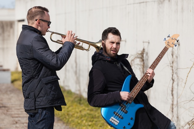 Free Photo holding trumpet in friends ear