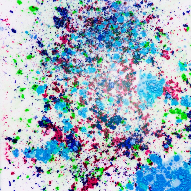 Free Photo holi colored powder splatter on white background