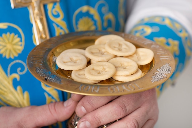 Holy communion concept with priest holding food