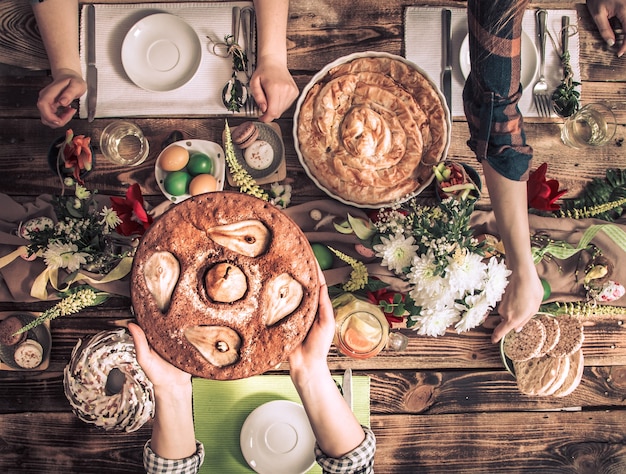 Free Photo home celebration of friends or family at the festive table with pear cake, top view, celebration concept