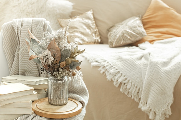 Home interior with books and dried flowers.