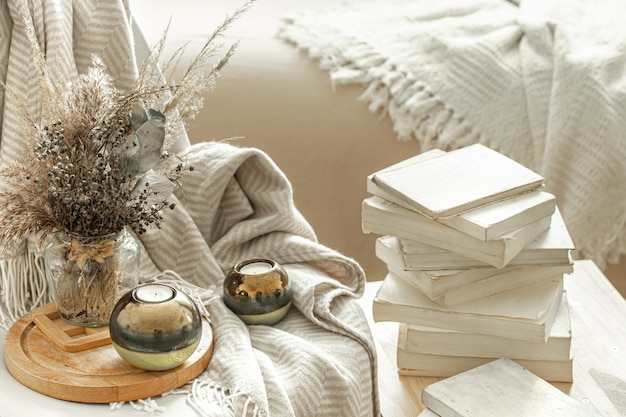 Free Photo home interior with books and dried flowers.