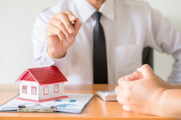 Home salesman stretches holding black pen.