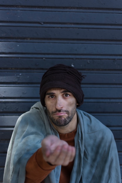 Free photo homeless man begging for money front view