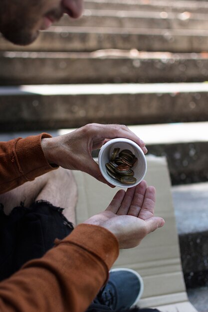 Homeless man counting his small change