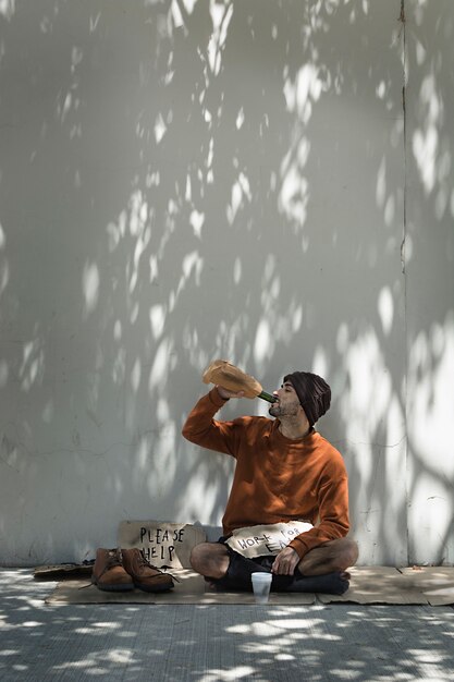 Homeless man drinking alcohol from a bottle