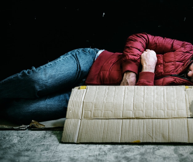 Free Photo homeless man sleeping out in the cold