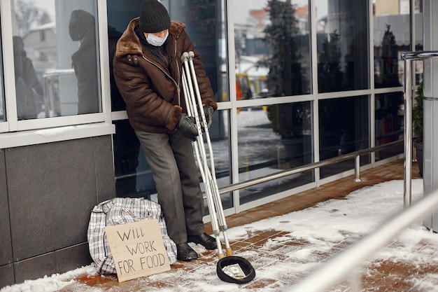 Free photo homeless standing near building.