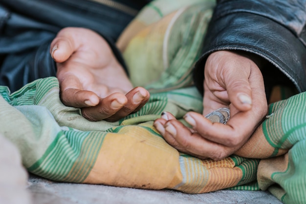 Homeless woman holding hands out for help