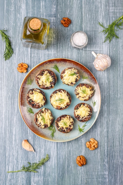 Free Photo homemade baked stuffed champignon mushrooms with fresh dill and cheese