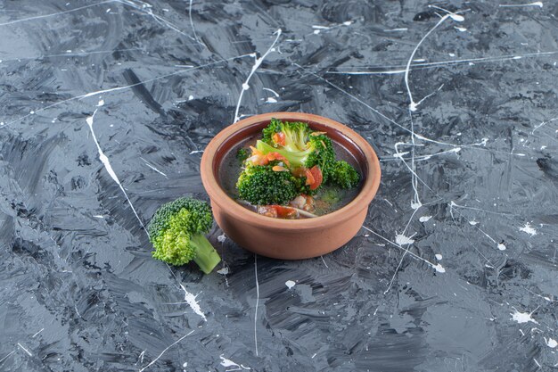 Homemade chicken soup in a bowl , on the marble surface.