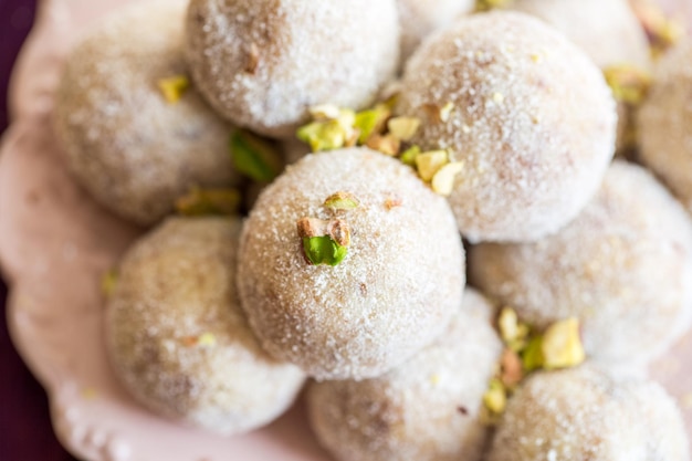 Free Photo homemade coconut balls decorated with little pink flowers