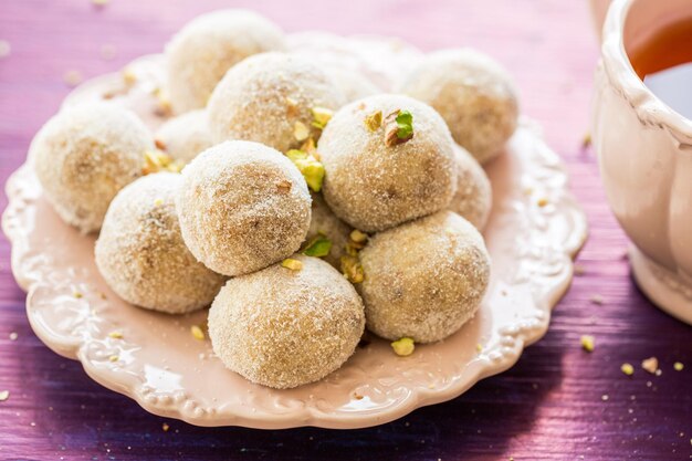 Free Photo homemade coconut balls decorated with little pink flowers