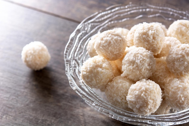 Free photo homemade coconut balls on wooden table