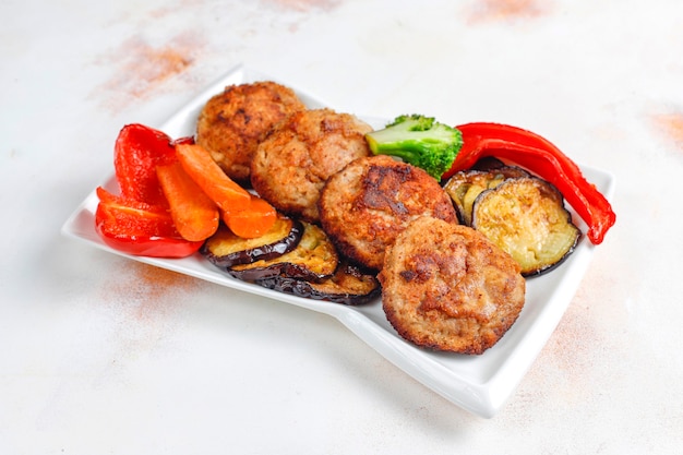 Homemade delicious cutlets with roasted vegetables.