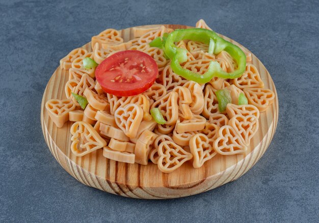 Homemade dinner with heart shaped pasta and vegetables.