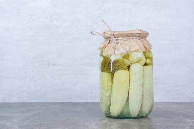 Homemade fermented cucumbers in glass jar.