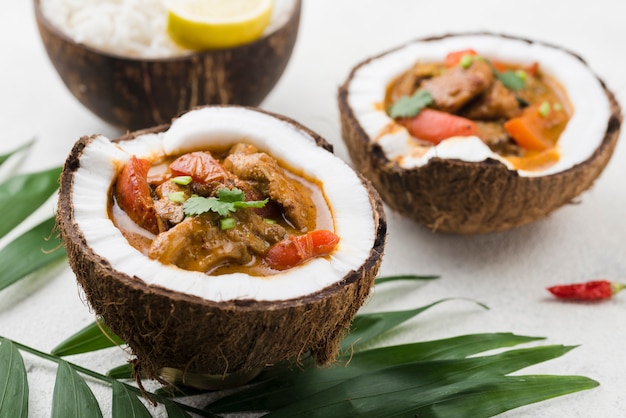 Free photo homemade fresh stew in coconut plates high view