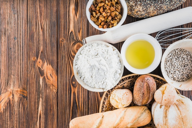 Free photo homemade freshly breads with ingredients on the wooden table