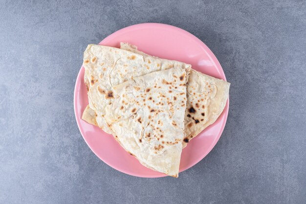 Homemade lavash bread on a plate , on the marble.