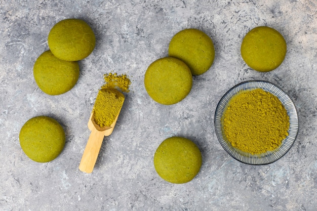 Free photo homemade matcha green tea cookies with matcha powder on grey concrete table