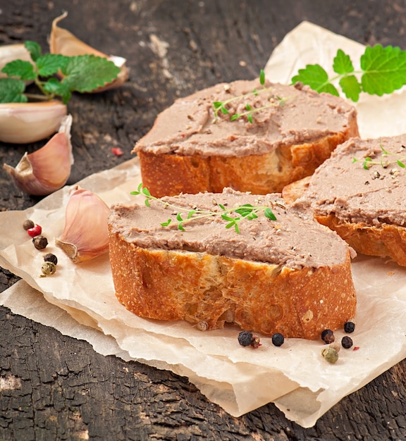 Homemade meat snack chicken liver pate with savory and olives