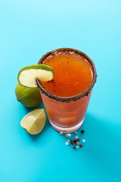 Homemade michelada cocktail with beer lime juicehot saucesalted rim and tomato juice