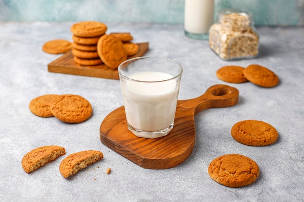 Homemade oatmeal cookies with a cup of milk.