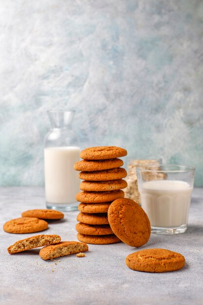 Homemade oatmeal cookies with a cup of milk.