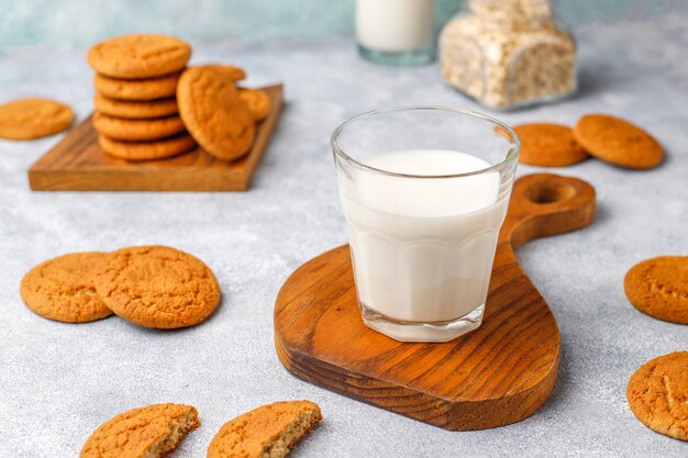 Homemade oatmeal cookies with a cup of milk.