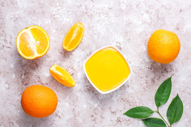 Homemade orange curd with juicy oranges.